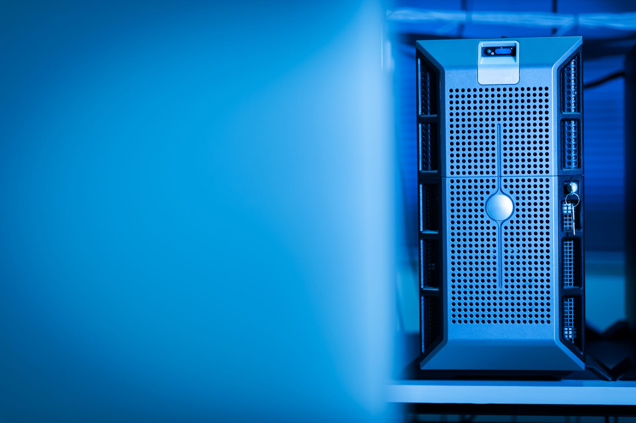 Close view of a server cabinet illuminated by blue light